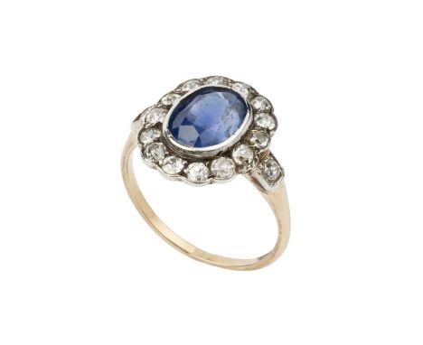 A sapphire and diamond cluster ring, the oval mixed-cut sapphire collet set within a border of old-cut diamonds, above a pier