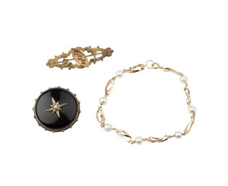 A Victorian onyx and half pearl memorial panel brooch, the circular onyx panel applied with a half pearl set star motif, to a