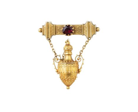A 19th century Archaeological Revival brooch, designed as a shaped bar with red paste accent, suspending an amphora-shaped sc