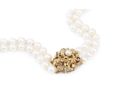 A cultured pearl double strand necklace with gem set clasp, comprising two strands of slightly graduated cultured pearls, to 