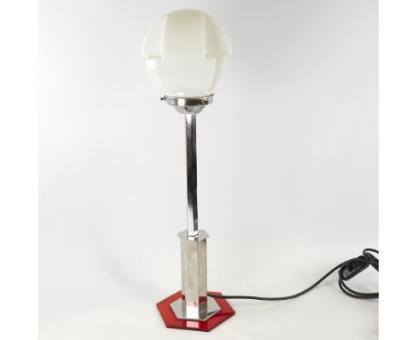 An Art Deco hexagonal table lamp, with chrome and bakelite body and white glass stepped shade, height 58cm.Good condition. 