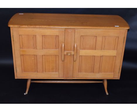 Mid-century light oak Ercol sideboard, two doors with central sliding catch, Ercol stamp to inside right hand door, 122cm wid