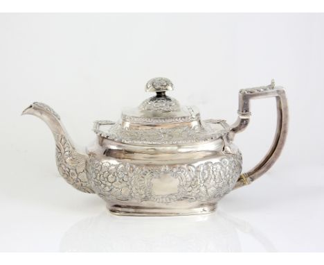 George IV Irish silver teapot, the squat oblong body profusely embossed with flowers and two vacant cartouches, the handle wi