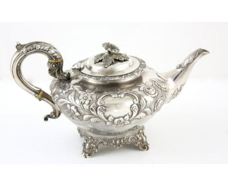 Victorian silver teapot with embossed floral decoration, on four scroll feet, by Frederick Dear, London, 1840, 24oz, 746g,PLE