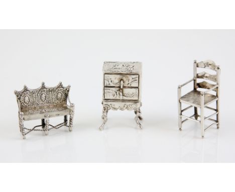 Three Dutch silver miniature pieces of furniture, comprising commode on stand, import marks for Chester 1904, ladderback chai