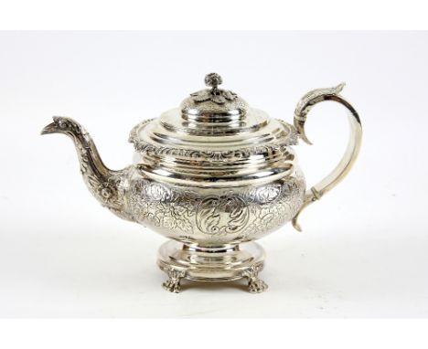 George IV round silver teapot, the body chased with flowers and with a crested cartouche, the cover with flower and leaf fini