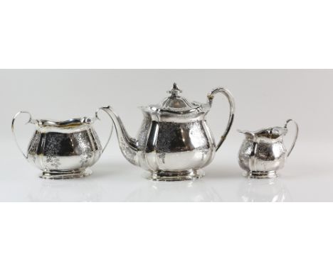 Edward VII silver three piece tea service, comprising tea pot, cream jug and sugar bowl, with bright cut floral decoration, o