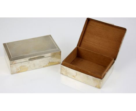 Two modern silver-mounted cigarette boxes, both with engine-turned decoration to the covers, the first by William Comyns &amp