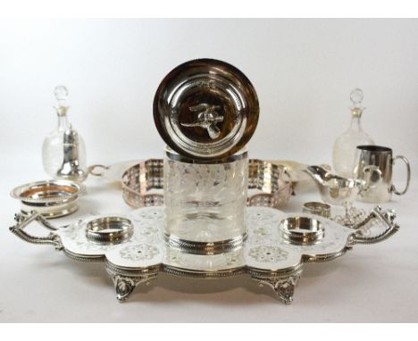 Silver plated decanter stand with two engraved glass decanters and a biscuit barrel, gallery tray and other items.   