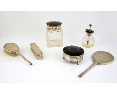 Two silver-mounted part dressing table sets, the first with silver and tortoiseshell-mounted covers to include perfume bottle