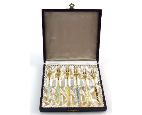 Danish set of six silver-gilt and enamel cocktail forks, each with two tines, in fitted case, by E L A, stamped Sterling, 10.