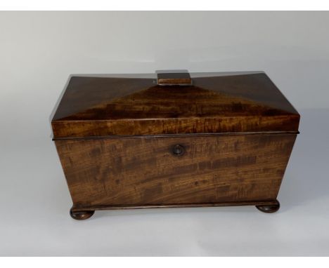 A mahogany sarcophagus shaped tea caddy, on four squat bun feet, 25cm L