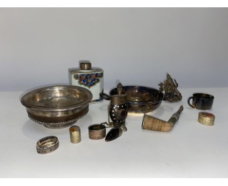An Asian white metal; mounted shallow decorative circular bowl, a tea caddy, pipe, scent bottle and small silver coloured fig