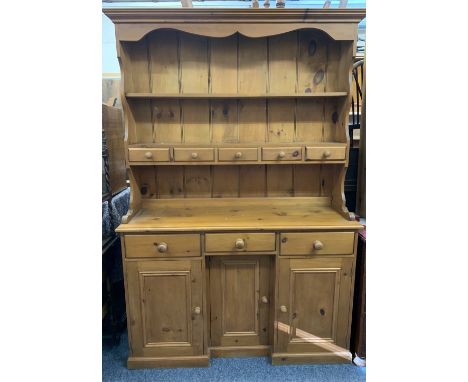 REPRODUCTION PINE INVERTED BREAKFRONT DRESSER having a two shelf rack with central spice drawers on a three drawer, three doo