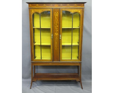 CIRCA 1900 INLAID MAHOGANY DISPLAY CABINET having a stepped cornice over a ribbon and floral swag decoration to a central pan