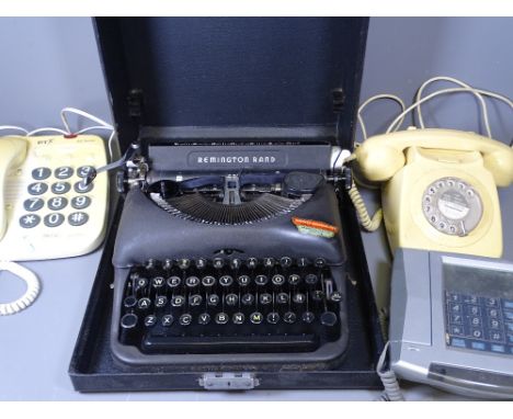 REMINGTON RAND VINTAGE TYPEWRITER IN A CASE and a quantity of old telephones