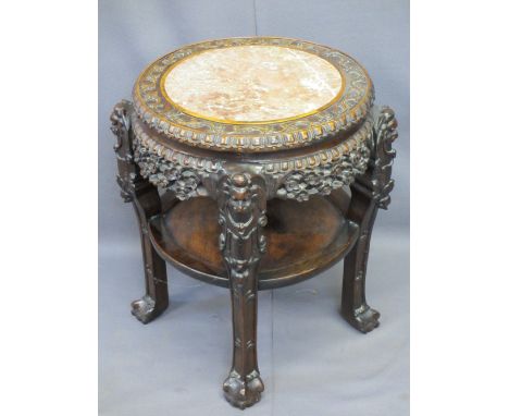 CHINESE CARVED HARDWOOD CIRCULAR STAND with pink marble inset top and under tier shelf, 68cms H, 43cms diameter the top