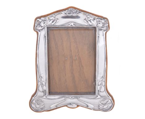 An Art Nouveau silver photograph frame, by Horace Woodward &amp; Co., Birmingham 1904, angle top shaped rectangular and embos