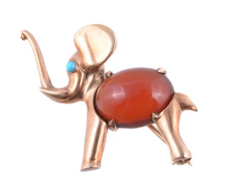 A novelty elephant brooch by Hans Georg Mautner, the elephant with trunk raised and circular cabochon turquoise eye, and oval