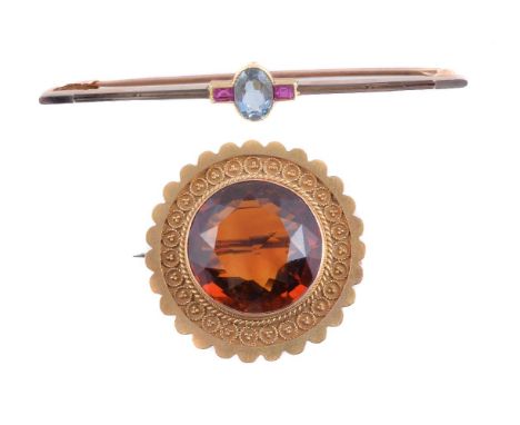 A late Victorian citrine brooch, the circular cut citrine within a beadwork surround, to a scalloped border, 3cm diameter; an