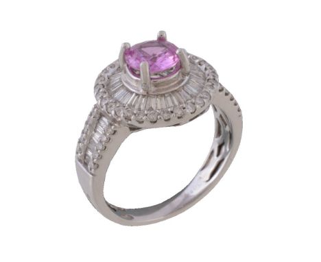 A pink sapphire and diamond cluster ring, the circular cut pink sapphire claw set within a surround of  baguette cut and bril