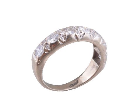 A diamond seven stone ring, set with seven brilliant cut diamonds, approximately 0.90 carats total, stamped 18ct, finger size