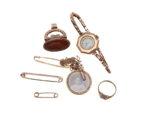 A small selection of jewellery, to include: a locket, on a chain; a wristwatch; a seal; a ring; and three brooches