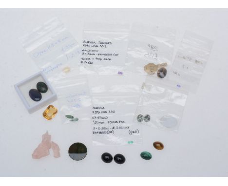 A collection of loose stones, to include two circular cut emeralds; two pear cut tourmalines; an oval cut tanzanite; an oval 