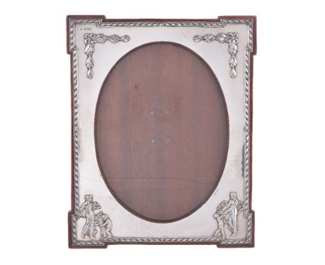 An Edwardian silver photograph frame by William Comyns &amp; Sons, London 1907, rectangular with outstanding angles and an ov