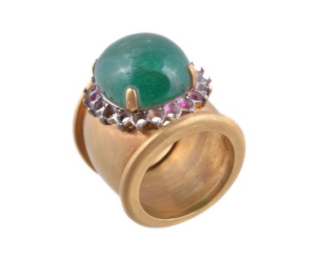 An emerald ring, the oval cabochon emerald in a four claw setting, on a wide shank, finger size L