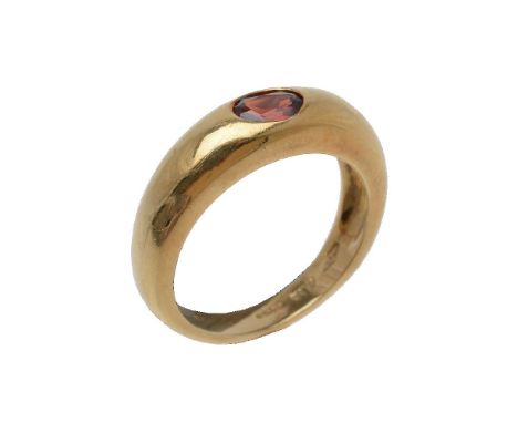 A garnet ring, the oval cut garnet collet set on a polished band, stamped 750 with Birmingham import marks for 1997, finger s
