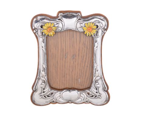 An Art Nouveau silver photograph frame, Henry Matthews over-striking that of another, Birmingham 1904, shaped rectangular, em