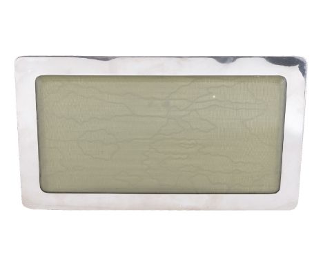 An Edwardian silver photograph frame by Lawrence Emmanuel, Birmingham 1908, plain long rounded rectangular, green moiré silk 