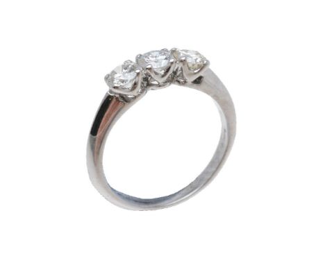 A three stone diamond ring, the three brilliant cut diamonds in claw settings, approximately 0.66 carats total, with partial 