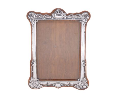 An Art Nouveau silver photograph frame by Horton &amp; Allday, Birmingham 1905, shaped rectangular and embossed with sinuous 