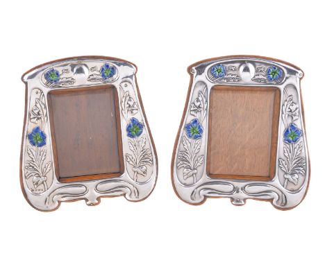 A pair of matched Arts and Crafts silver photograph frames, by William Aitken, Birmingham 1904, and by Walker &amp; Hall, She