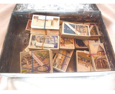 Vintage tin containing Churchman's cigarette cards