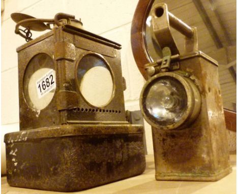 Hand held antique railway lantern and a hand held vintage torch