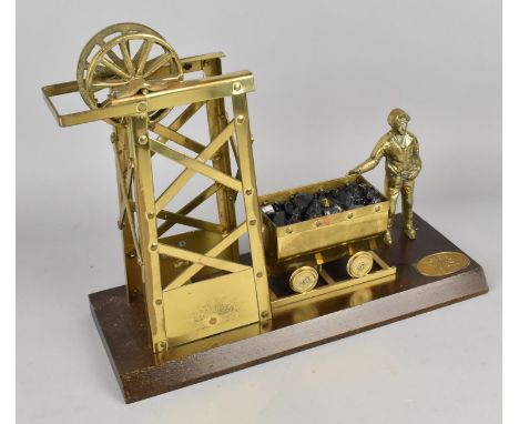 A Vintage Brass Model of Welsh Miner, Coal Cart and Pit Head on Wooden Plinth, 33cms Wide