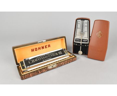 A Taktell Junior Metronome by Wittner and a Hohner Cased Chromonika III