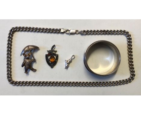 SILVER NAPKIN RING, SILVER TEDDY BEAR WITH UMBRELLA BROOCH, SILVER WINNIE THE POOH PENDANT, SHIELD SHAPED FOB AND A SILVER FL