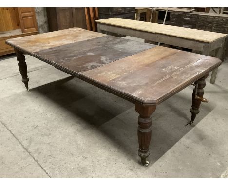 Late Victorian walnut dining table, moulded rectangular top with canted corners, two additional leaves and telescopic extendi