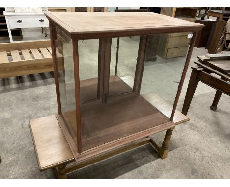 Early 20th century stained pine and glazed shop display cabinet, glass front and sides, fitted with two cupboard doors with m