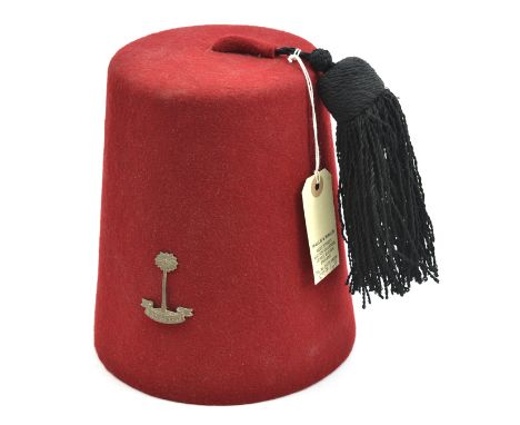 A crimson cloth fez, with tassel, RWAFF badge, silk lining, leather headband with tailor’s name “Denham & Hargreave Ltd, Athe