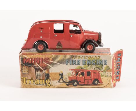 A Tri-ang Minic clockwork Fire Engine. Complete with rubber tyres, bell, locker covers and one plastic ladder. Hose to rear i