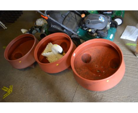 Three matching plastic planters and a planter in the form of a swan
