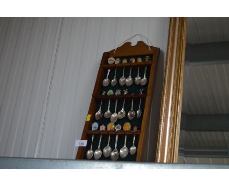A souvenir spoon display rack and contents 