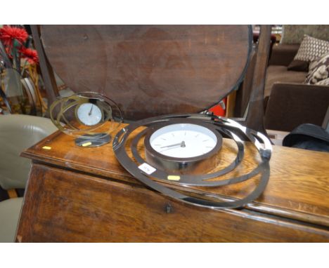 A modern mantle clock and matching wall clock