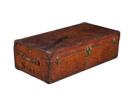 A FRENCH LEATHER AND BRASS STUDDED TRAVEL TRUNK BY AU DEPART OF PARIS, CIRCA 1900 With makers plaques to each side, makers la