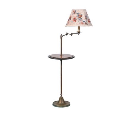 A BRASS ADJUSTABLE STANDARD READING LAMP MID 20TH CENTURY, POSSIBLY SUPPLIED BY GEOFFREY BENNISON The adjustable arm above a 
